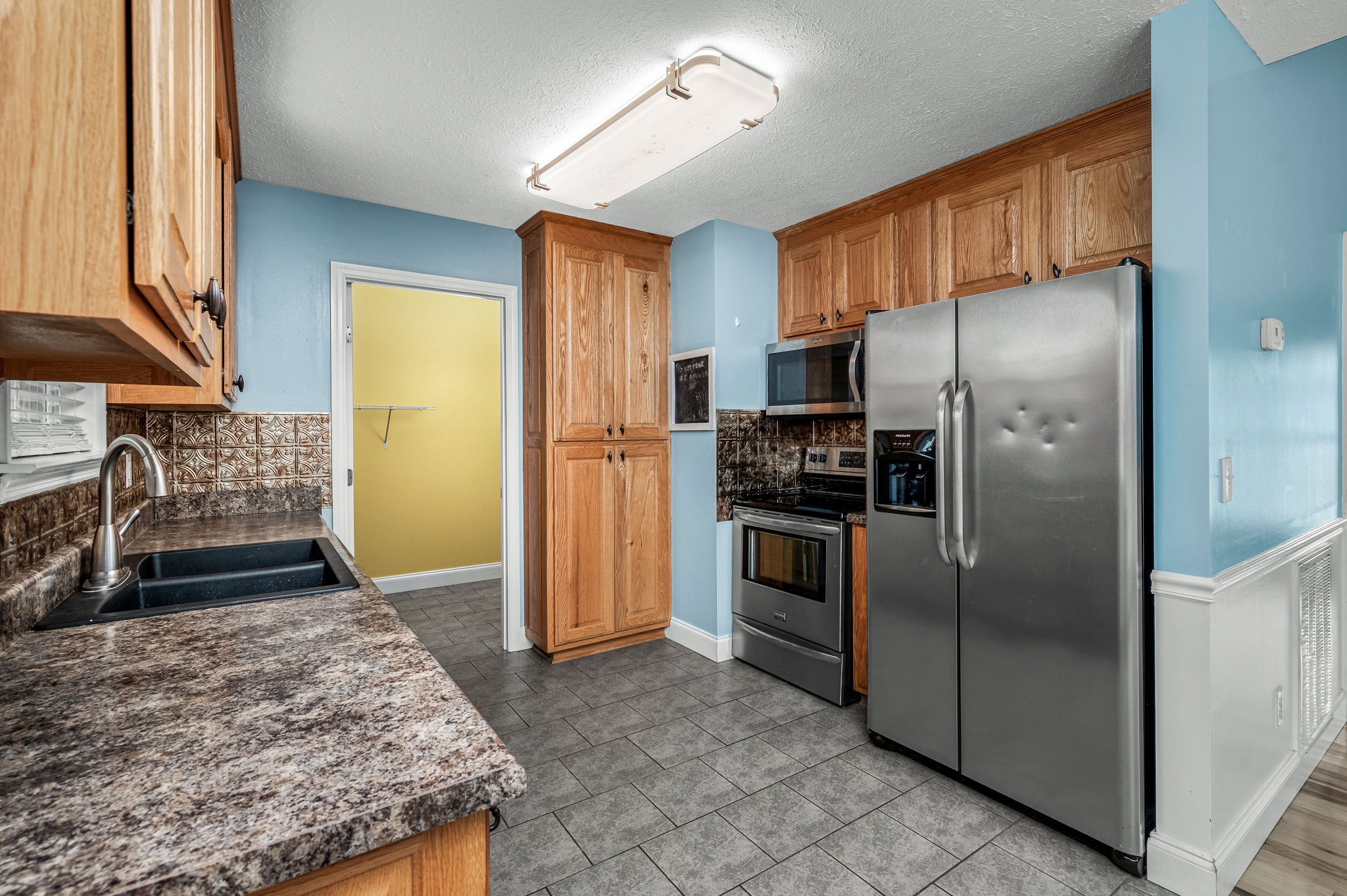 24 Shady Grove Cemetery Road Flintville, TN 37335 - Photo 22 of 40 a kitchen with granite countertop a refrigerator and a sink