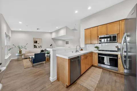 a kitchen with a sink cabinets and stainless steel appliances