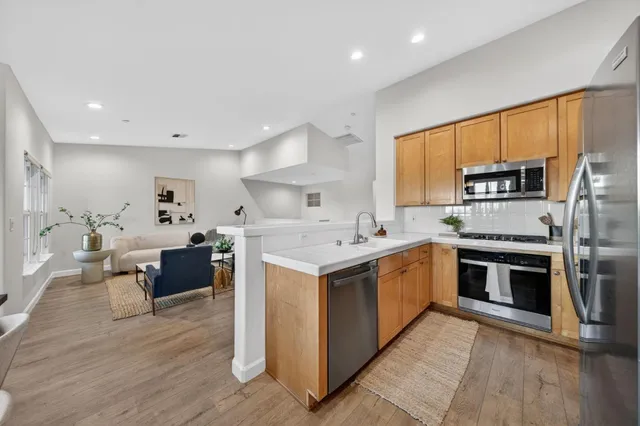 a kitchen with a sink cabinets and stainless steel appliances