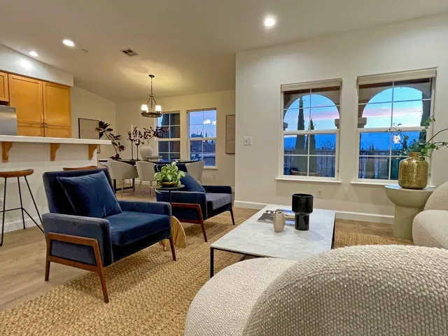 a living room with furniture and a potted plant
