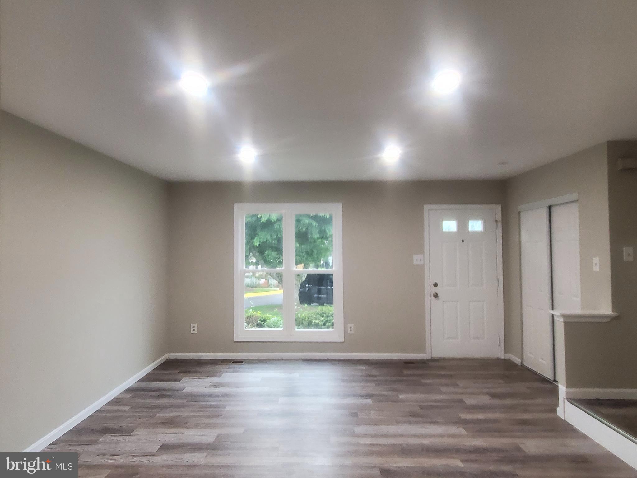 14813 Hammersmith Circle Silver Spring, MD 20906 - Photo 4 of 36 an empty room with wooden floor and windows