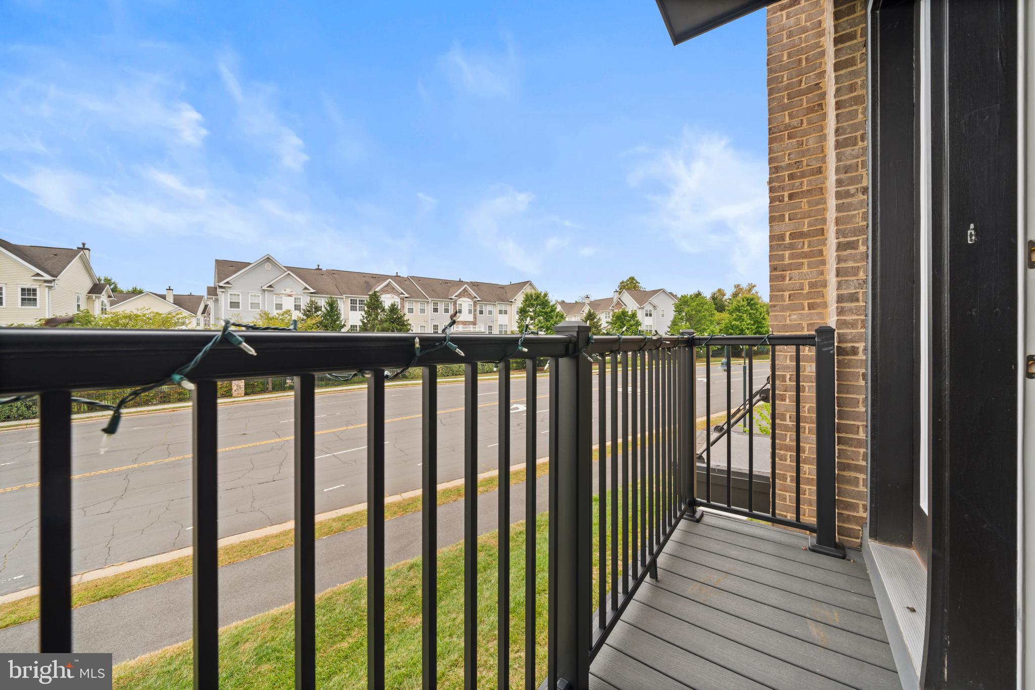 43382 Farringdon Square Broadlands, VA 20148 - Photo 11 of 34 a view of a balcony with wooden floor & fence and city view