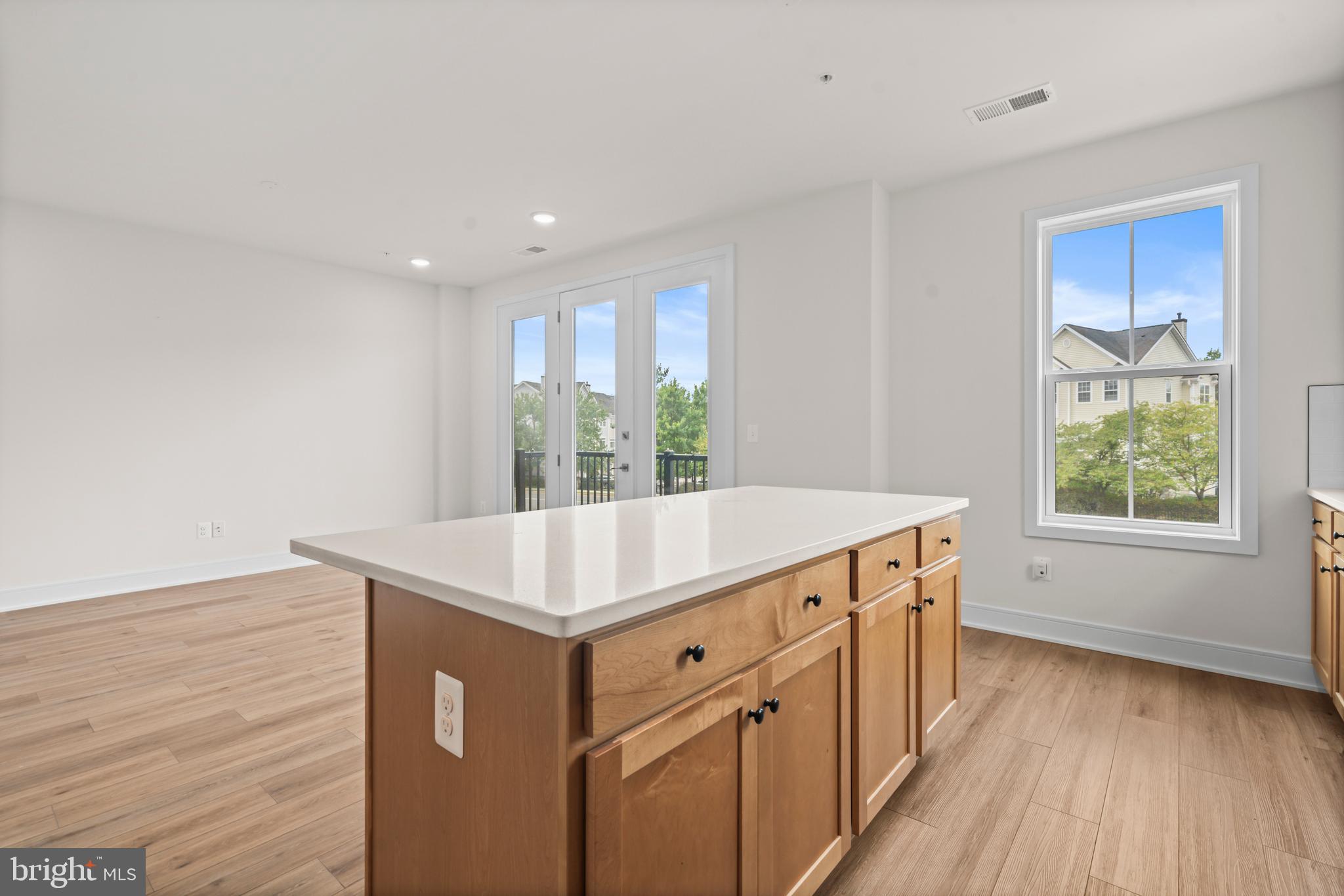 43382 Farringdon Square Broadlands, VA 20148 - Photo 16 of 34 a kitchen with a stove and wooden floor