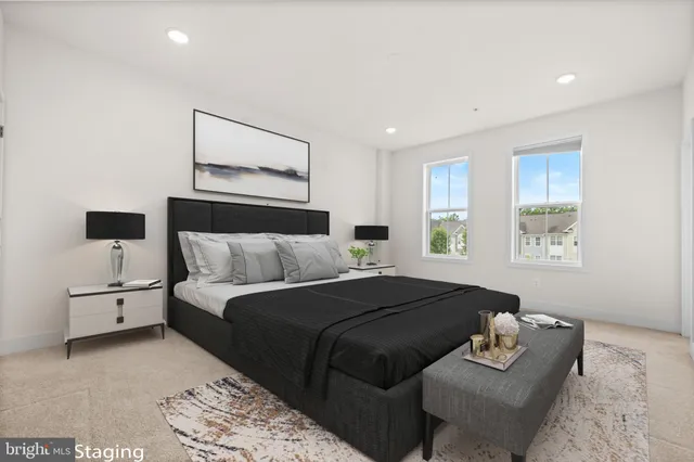 a bedroom with a bed couch and window