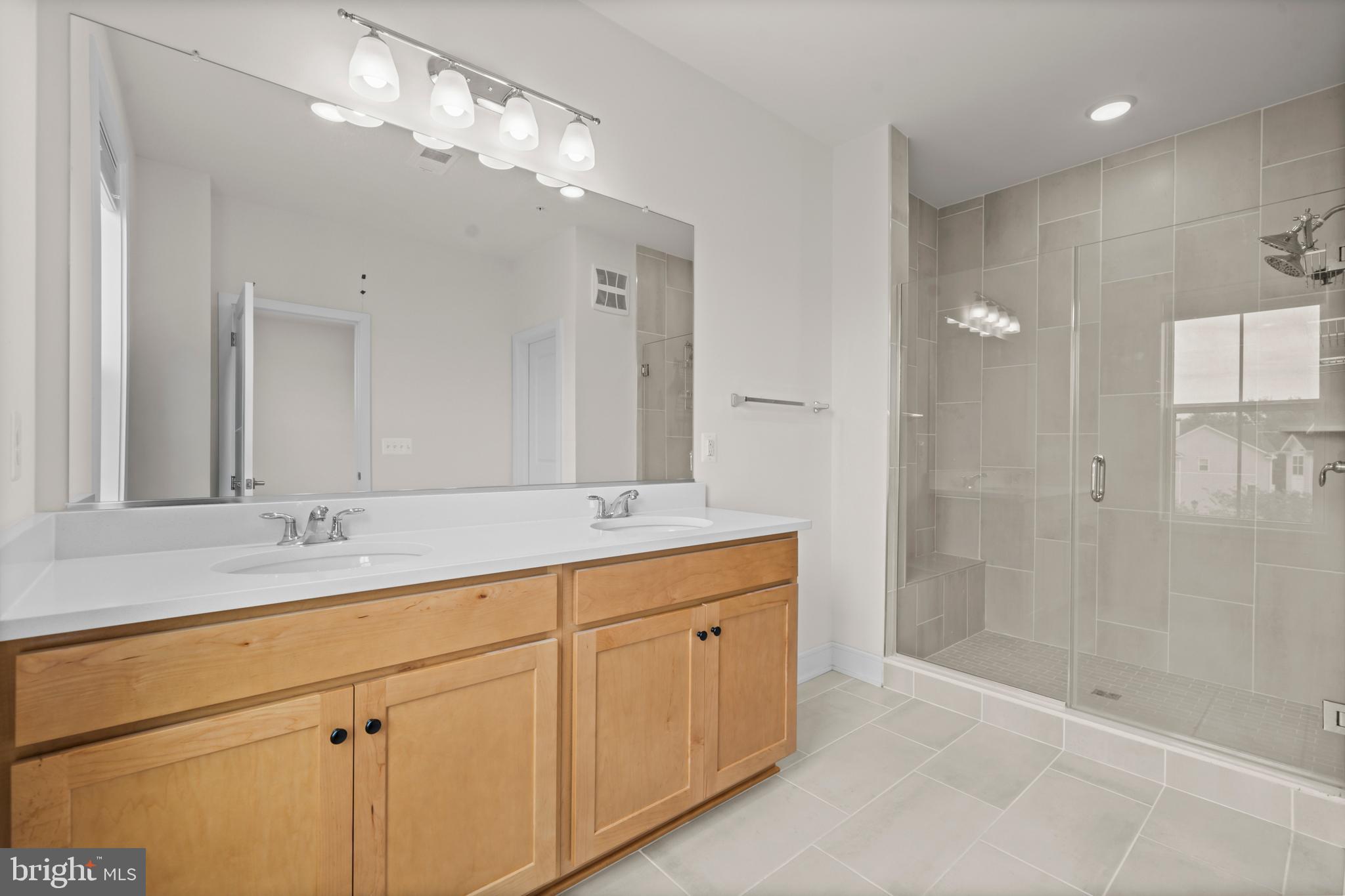 43382 Farringdon Square Broadlands, VA 20148 - Photo 22 of 34 a bathroom with a double vanity sink mirror and shower