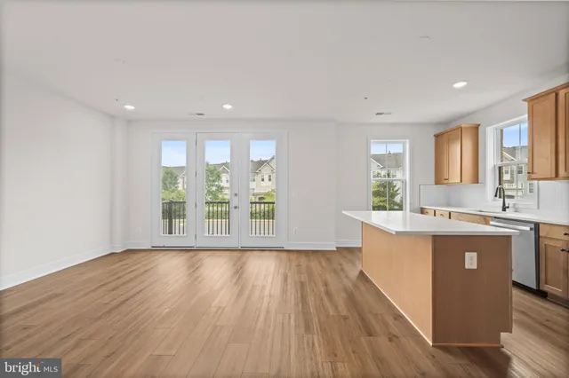 a view of kitchen with wooden floor and electronic appliances