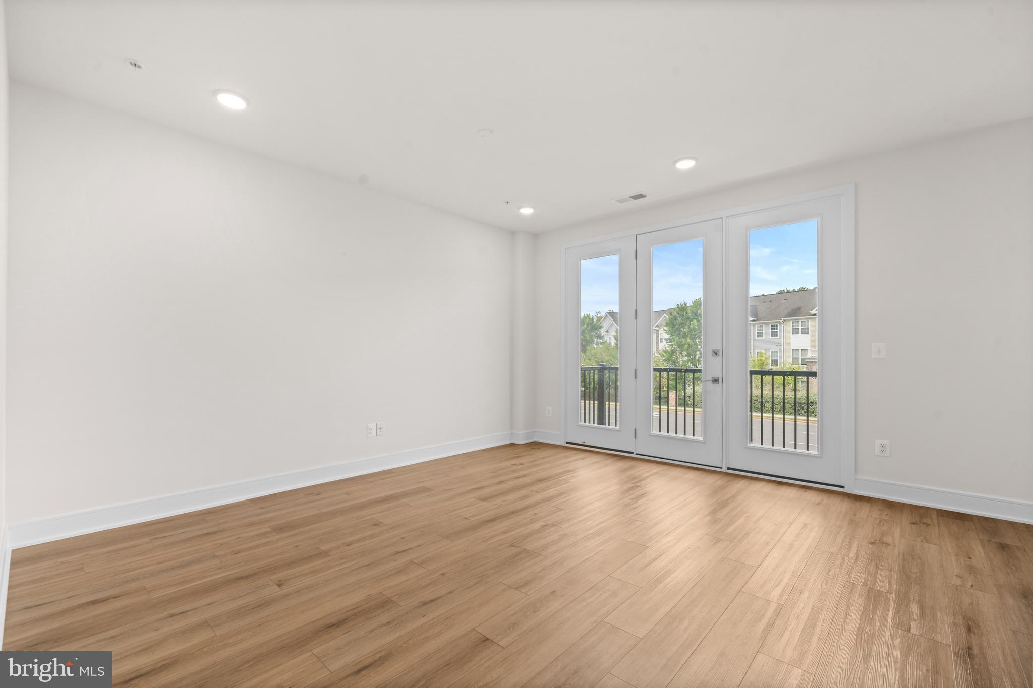 43382 Farringdon Square Broadlands, VA 20148 - Photo 10 of 34 a view of an empty room with wooden floor and a window