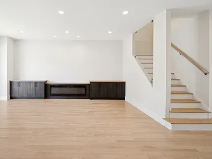 a view of an empty room with stairs and stairs