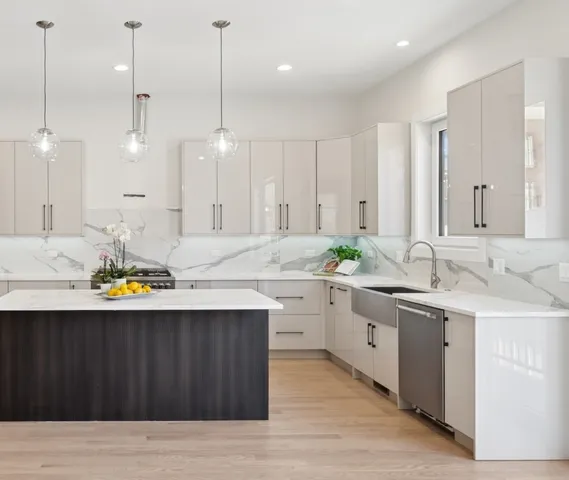 a kitchen with a sink cabinets and wooden floor