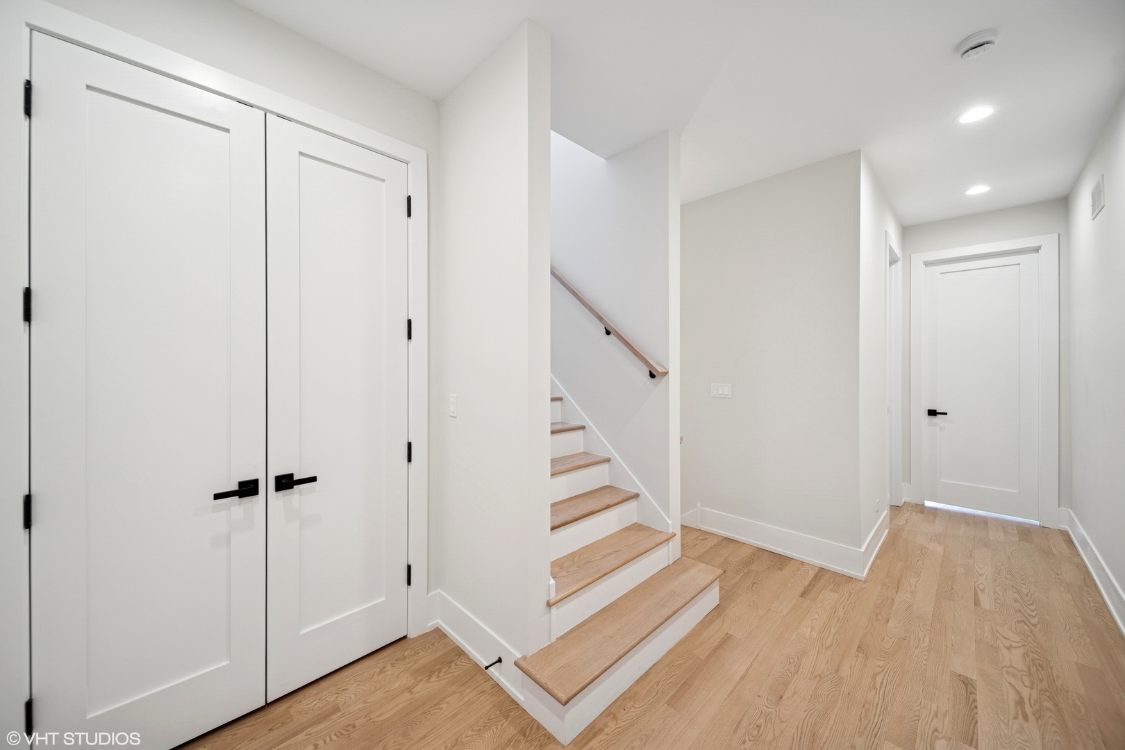 967 East 62nd Street, Unit 2 Chicago, IL 60637 - Photo 6 of 8 a view of a hallway with wooden floor and staircase