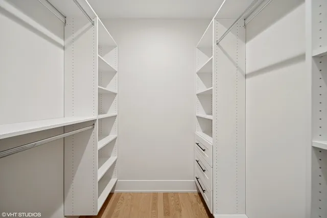 a spacious bathroom with a double vanity sink and mirror