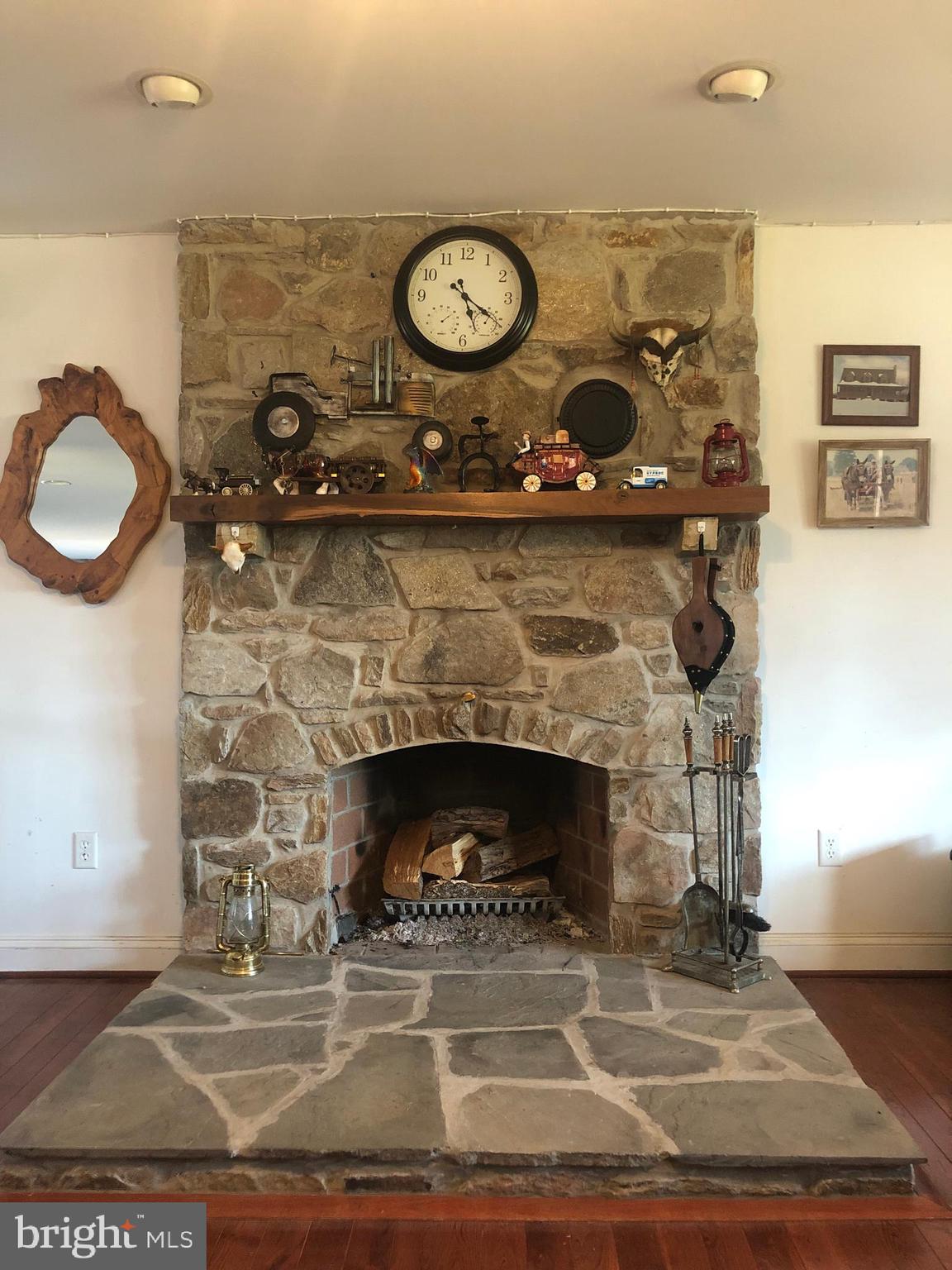 12550 Shoemaker Road Taneytown, MD 21787 - Photo 11 of 53 a stone fireplace with a clock on it
