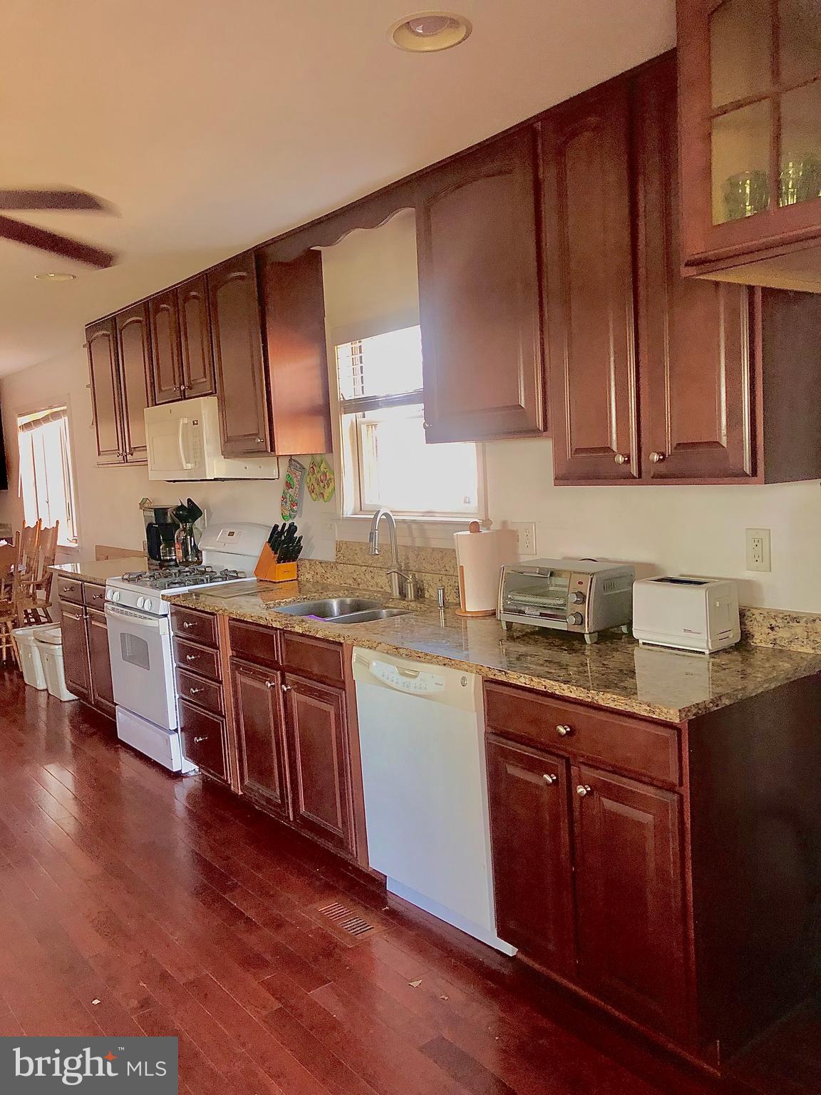 12550 Shoemaker Road Taneytown, MD 21787 - Photo 15 of 53 a kitchen with stainless steel appliances granite countertop wooden cabinets a stove top oven a sink and dishwasher with wooden floor