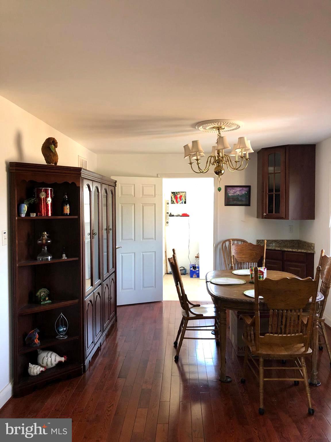 12550 Shoemaker Road Taneytown, MD 21787 - Photo 19 of 53 a view of a dining room with furniture and wooden floor