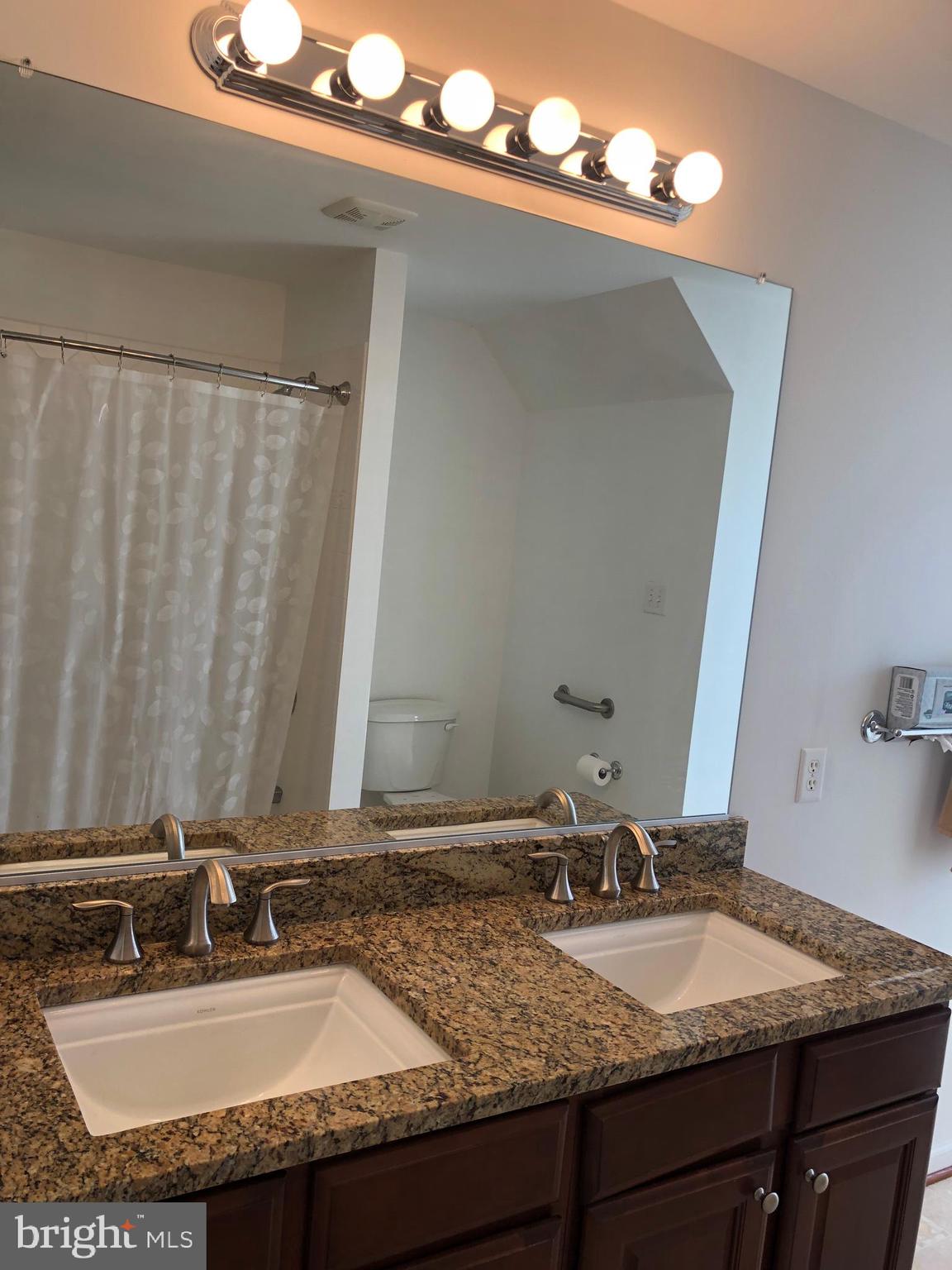 12550 Shoemaker Road Taneytown, MD 21787 - Photo 32 of 53 a bathroom with a granite countertop sink and a mirror