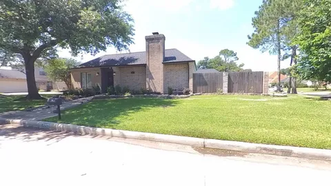 a house with a yard and a large tree