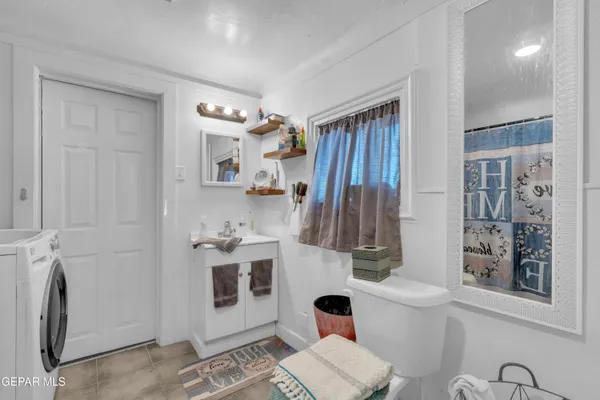 a bathroom with a sink a toilet and a mirror