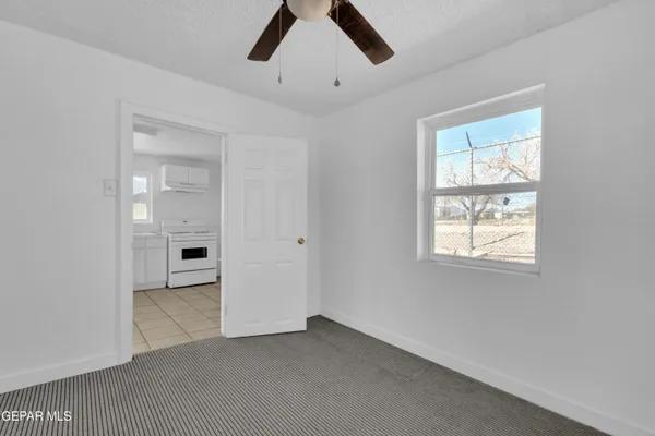 a kitchen with a refrigerator and cabinets