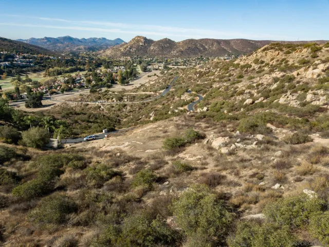 a view of a large mountain with mountains in the background