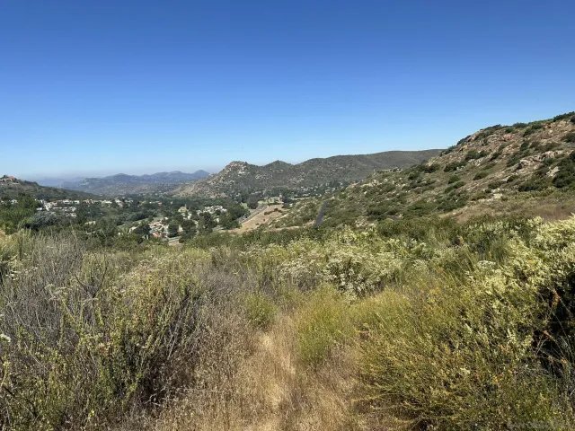 a view of a large building with mountains in the background