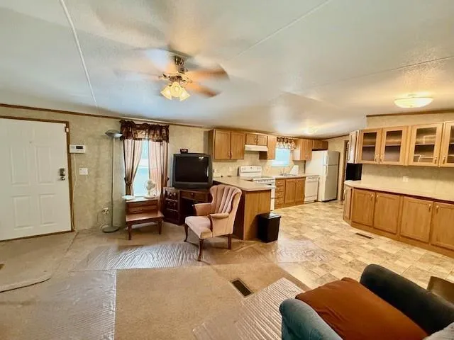 a kitchen with stainless steel appliances granite countertop a stove a sink dishwasher and a refrigerator