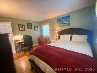 a bedroom with a bed a table and chair