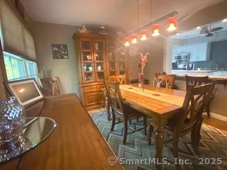 a dining area with furniture and chandelier