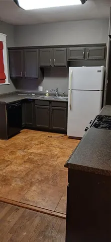 a kitchen with granite countertop a sink and a stove