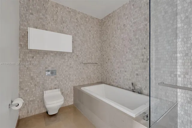 a bathroom with a toilet and bathtub
