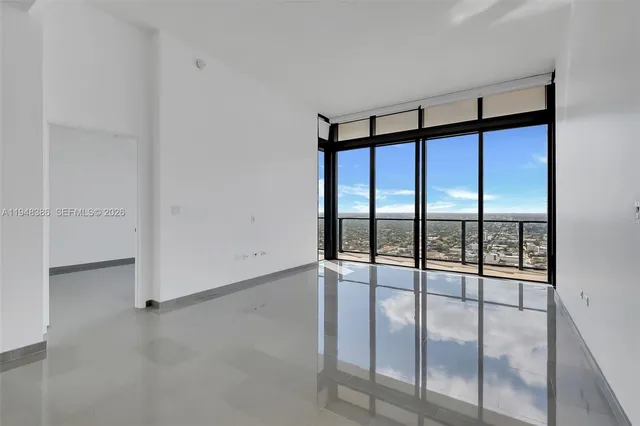 an empty room with sliding glass door
