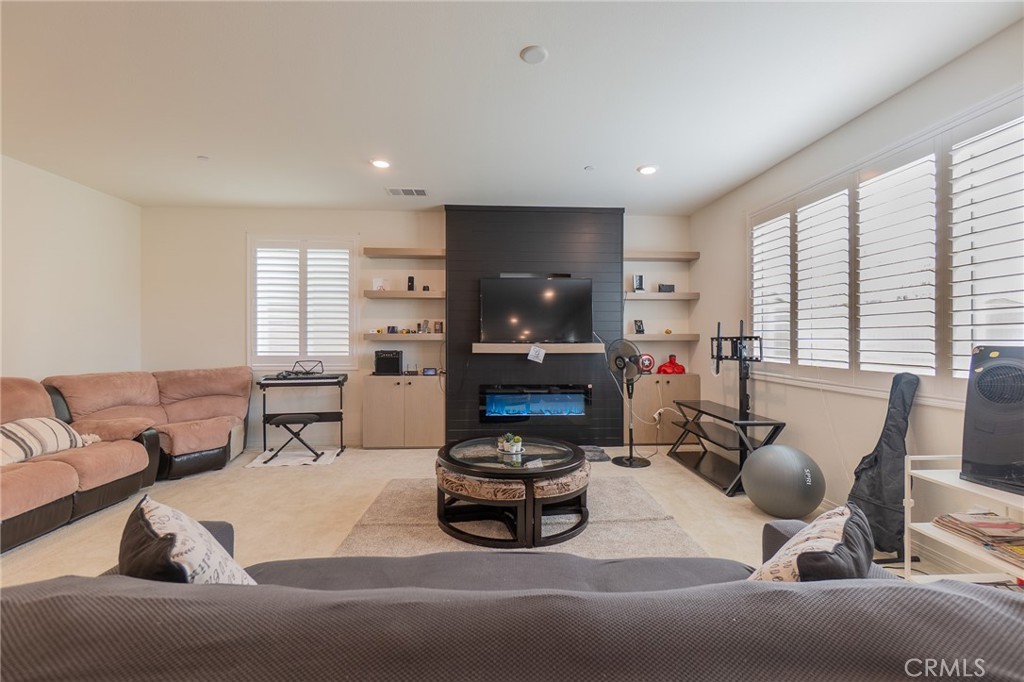 1099 Little Leaf Street Calimesa, CA 92320 - Photo 11 of 32 a living room with furniture and a fireplace
