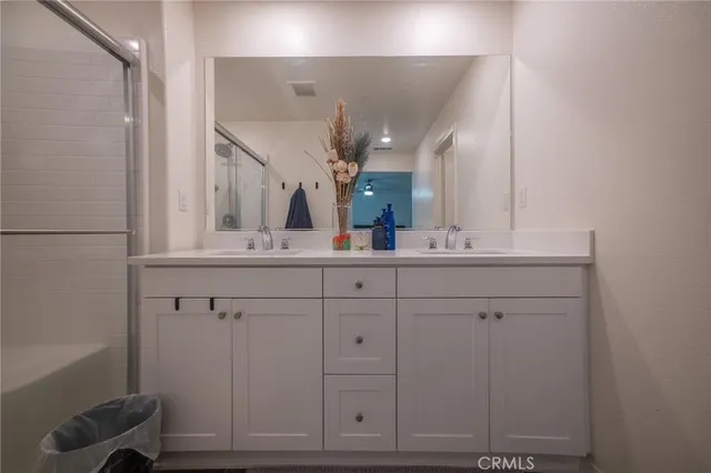 a bathroom with a sink vanity and mirror