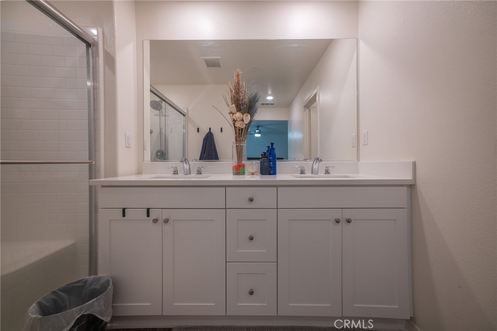 1099 Little Leaf Street Calimesa, CA 92320 - Photo 15 of 32 a bathroom with a sink vanity and mirror