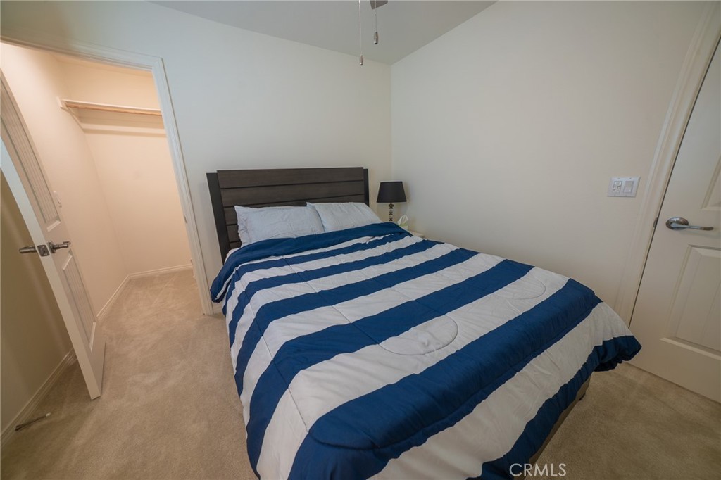 1099 Little Leaf Street Calimesa, CA 92320 - Photo 17 of 32 a bedroom with a bed and a window