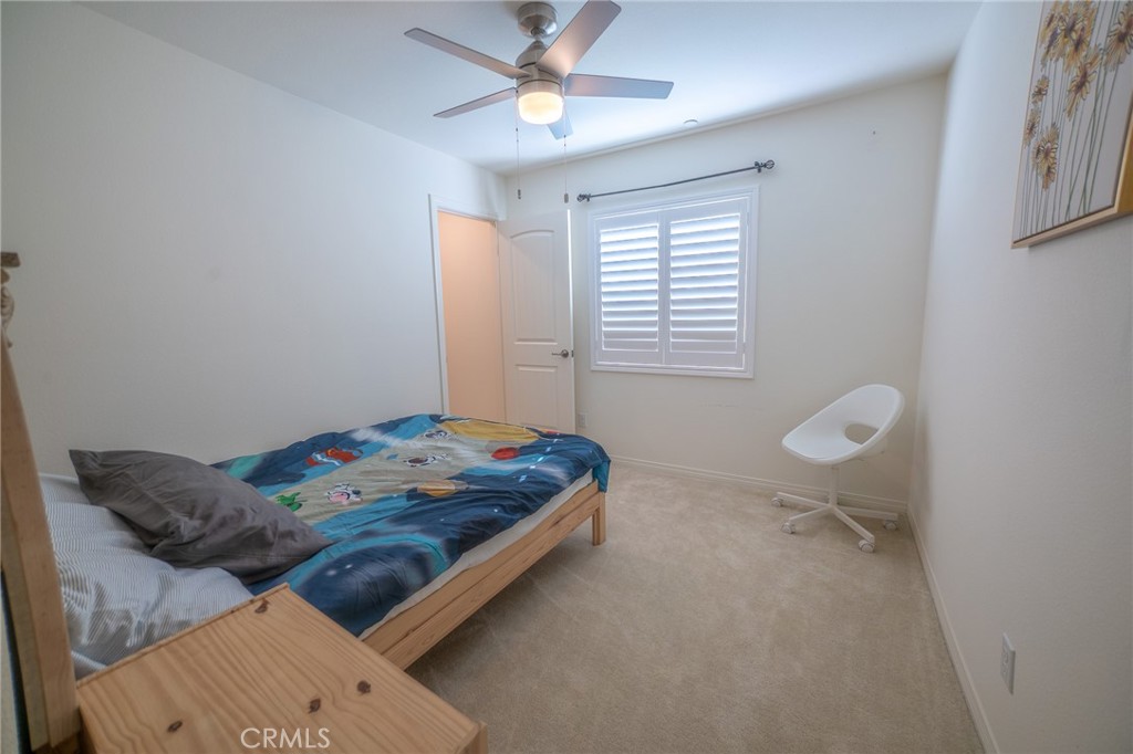 1099 Little Leaf Street Calimesa, CA 92320 - Photo 20 of 32 a bedroom with a bed and a window