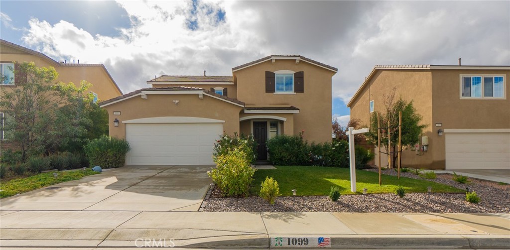 1099 Little Leaf Street Calimesa, CA 92320 - Photo 2 of 32 a front view of a house with garden