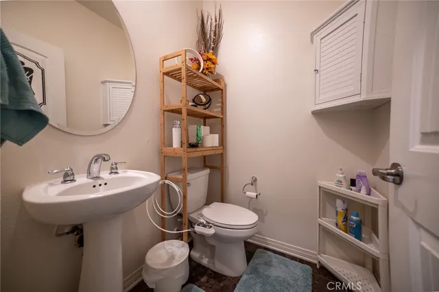 a bathroom with a sink toilet and a mirror