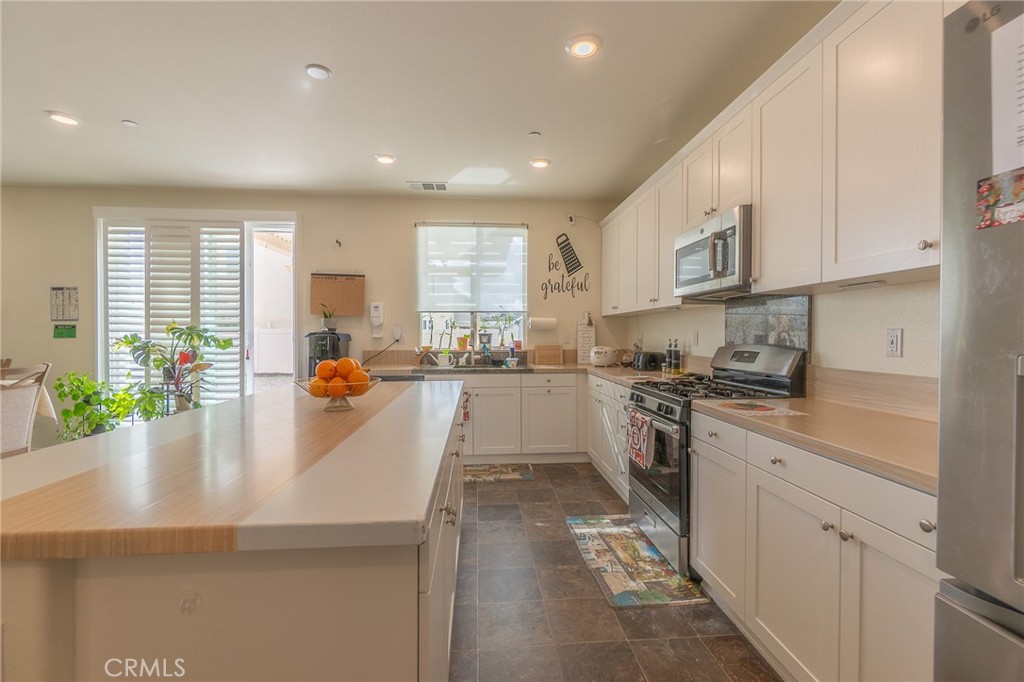 1099 Little Leaf Street Calimesa, CA 92320 - Photo 4 of 32 a kitchen with sink a counter top space and appliances