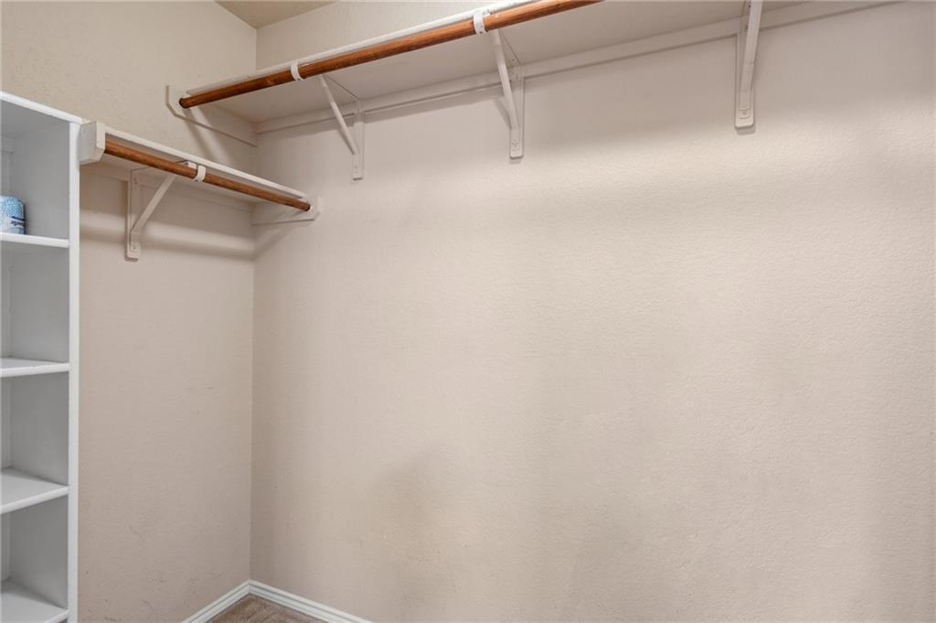 20224 Merlin Falcon Trail Pflugerville, TX 78660 - Photo 29 of 40 Ample storage solutions define this practical walk-in closet, ready for personalized organization.
