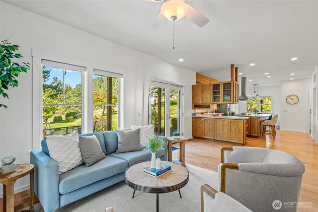 a living room with furniture kitchen and a chandelier