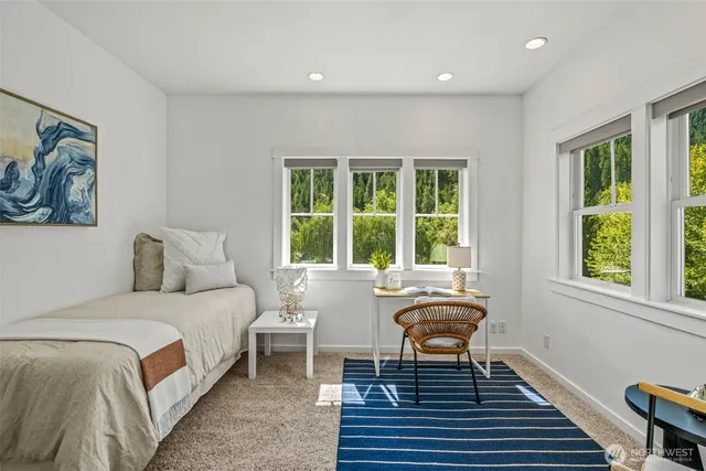 a bedroom with a bed and a large window