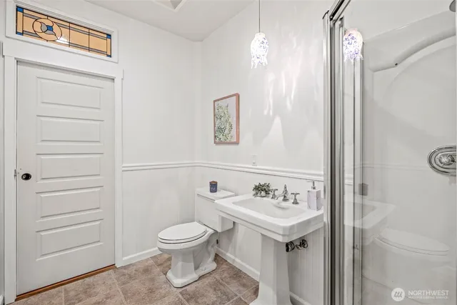 a bathroom with a toilet sink and mirror