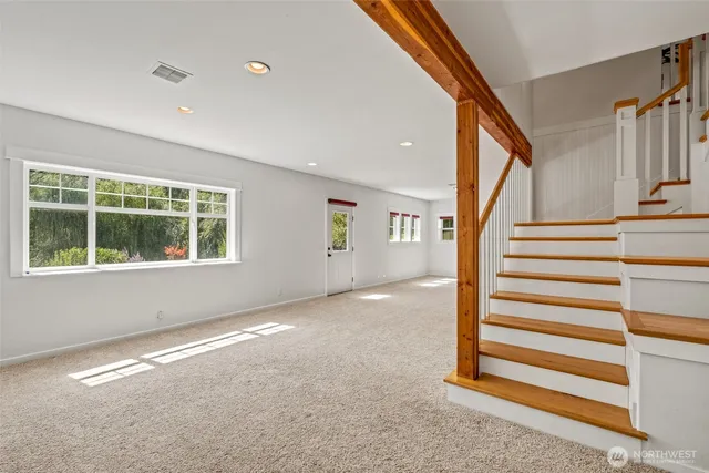 a view of wooden floor and windows in a room