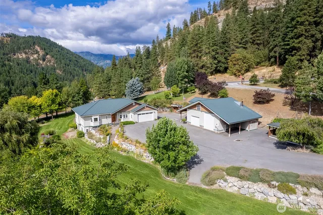 an aerial view of a house with yard and green space