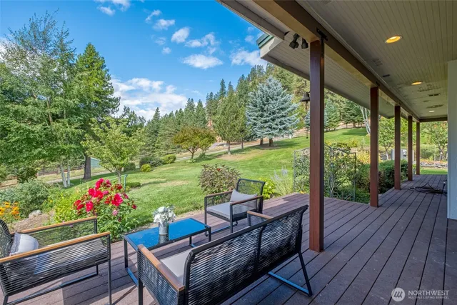 a view of a chairs and table in patio with wooden floor