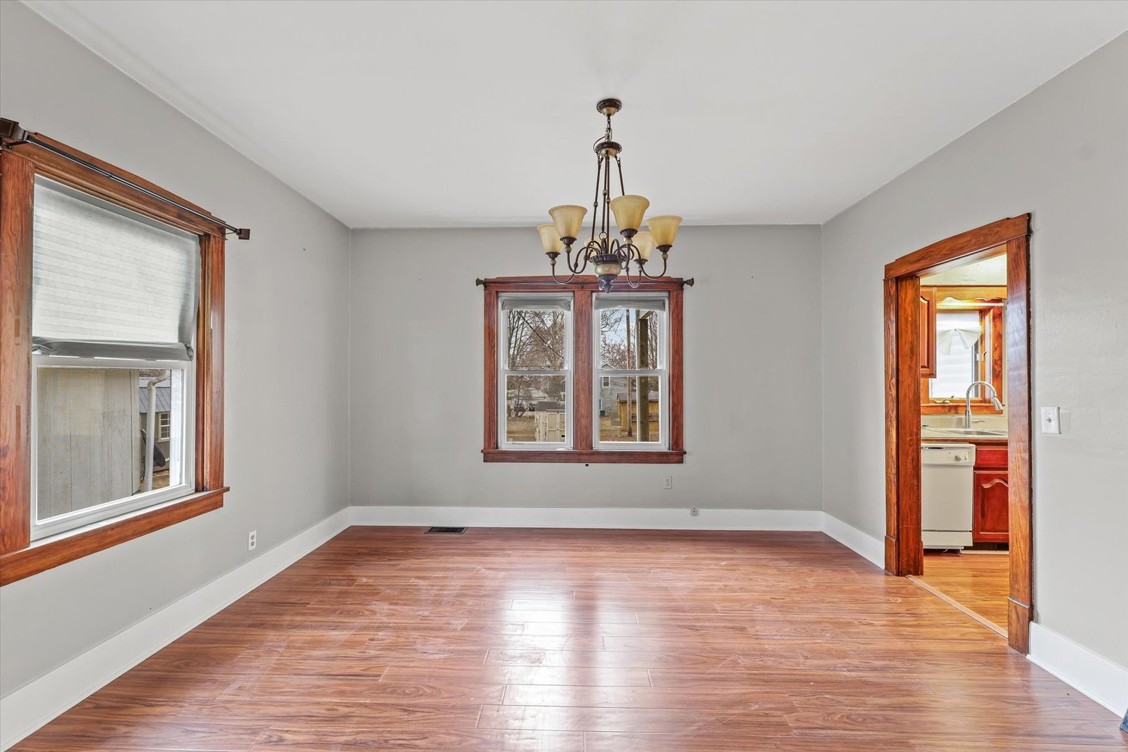 113 Columbus Street Sibley, IL 61773 - Photo 11 of 39 a view of an empty room with wooden floor and a window