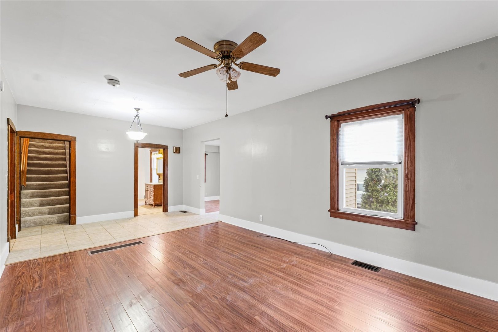 113 Columbus Street Sibley, IL 61773 - Photo 9 of 39 a view of an empty room with wooden floor and a window