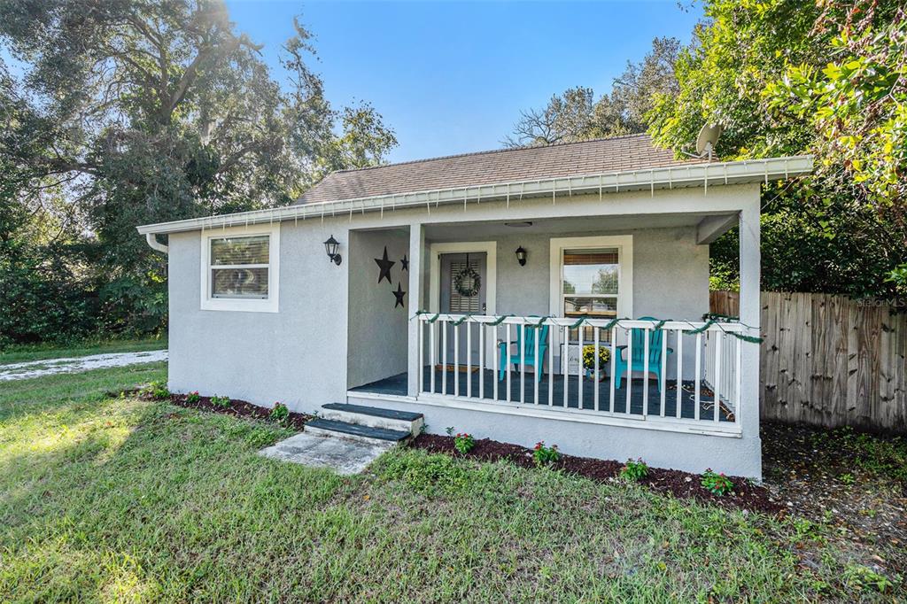 4921 6th Street Zephyrhills, FL 33542 - Photo 1 of 15 a view of a house with a yard and deck