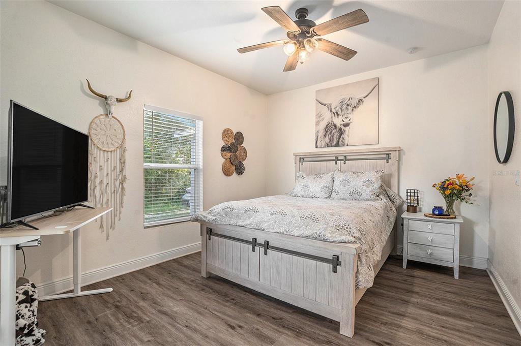 4921 6th Street Zephyrhills, FL 33542 - Photo 12 of 15 a bedroom with a bed and a flat screen tv