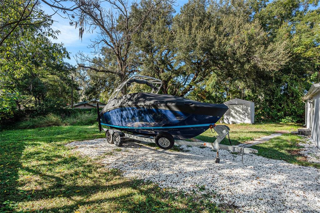 4921 6th Street Zephyrhills, FL 33542 - Photo 14 of 15 a view of a backyard with table and chairs plants and trees